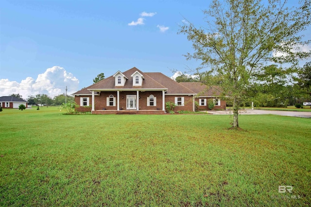 view of front of house featuring a front lawn and covered porch