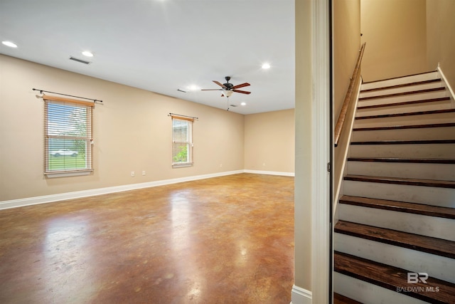 spare room featuring concrete flooring and ceiling fan