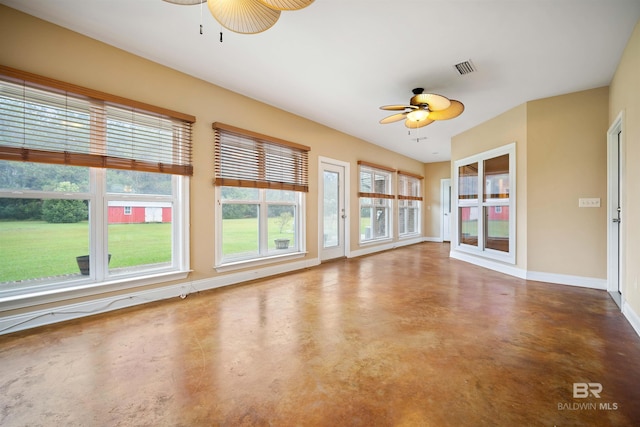 unfurnished sunroom with ceiling fan