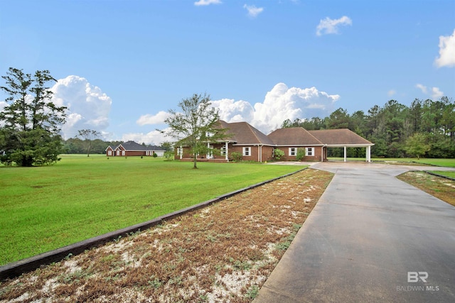 single story home featuring a carport and a front yard