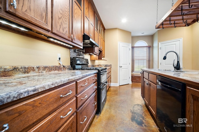 kitchen featuring black appliances, sink, and light stone counters