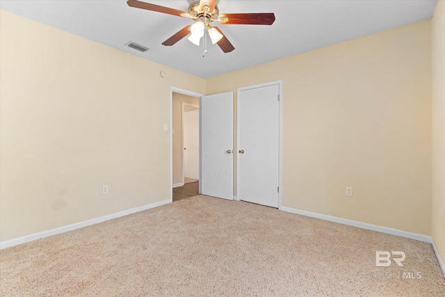 unfurnished bedroom with a ceiling fan, visible vents, light carpet, and baseboards