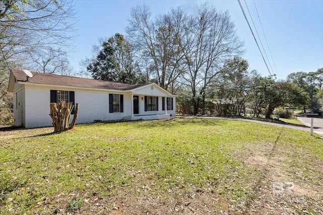 view of front of house featuring a front yard and brick siding