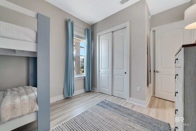 3214 Dolphin Dr, Gulf Shores, AL 36542 - bedroom featuring visible vents, a closet, baseboards, and wood finished floors