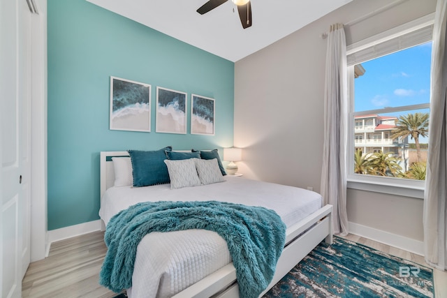 3214 Dolphin Dr, Gulf Shores, AL 36542 - bedroom with ceiling fan, baseboards, and wood finished floors