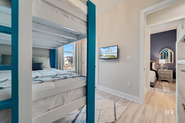 3214 Dolphin Dr, Gulf Shores, AL 36542 - bedroom featuring beamed ceiling, light wood finished floors, and baseboards