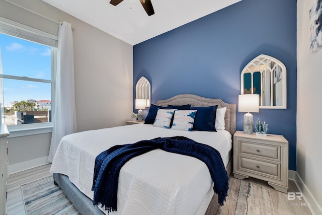 3214 Dolphin Dr, Gulf Shores, AL 36542 - bedroom featuring baseboards, a ceiling fan, and wood finished floors