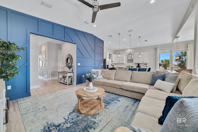 3214 Dolphin Dr, Gulf Shores, AL 36542 - living room with a decorative wall, lofted ceiling, visible vents, and ceiling fan