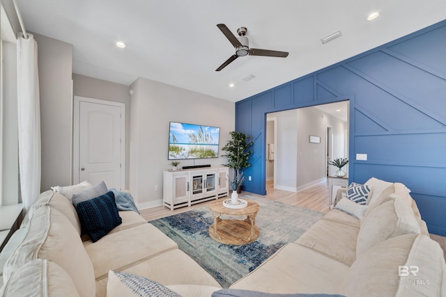3214 Dolphin Dr, Gulf Shores, AL 36542 - living room featuring baseboards, light wood-style floors, visible vents, ceiling fan, and a decorative wall
