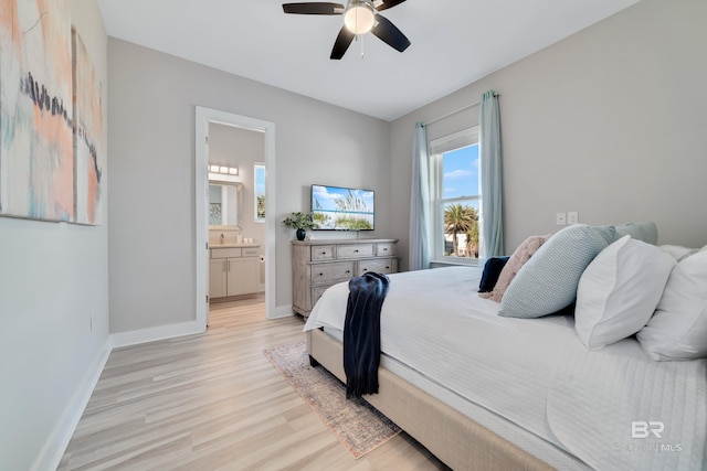 3214 Dolphin Dr, Gulf Shores, AL 36542 - bedroom with light wood-style flooring, ceiling fan, ensuite bathroom, and baseboards
