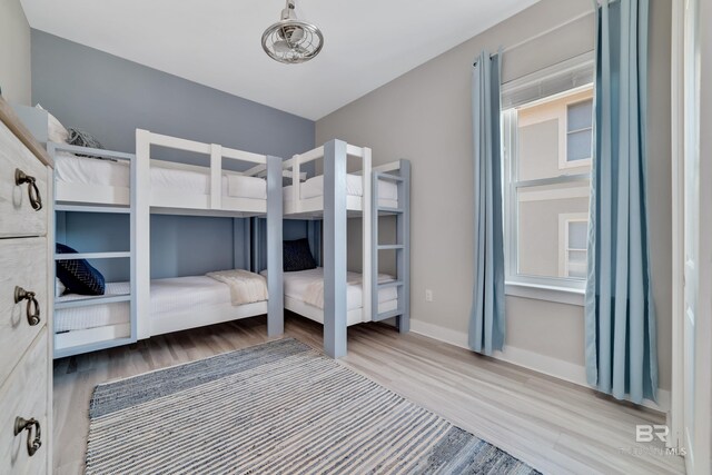 3214 Dolphin Dr, Gulf Shores, AL 36542 - unfurnished bedroom featuring baseboards and wood finished floors