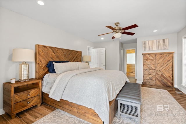 bedroom featuring ensuite bathroom, ceiling fan, and hardwood / wood-style floors