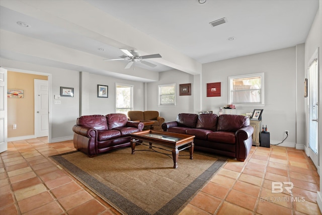 tiled living room with ceiling fan