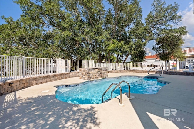 view of swimming pool featuring pool water feature and a patio area