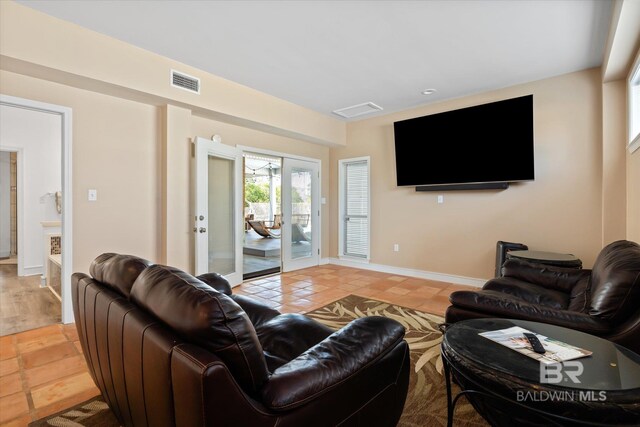 tiled living room featuring french doors