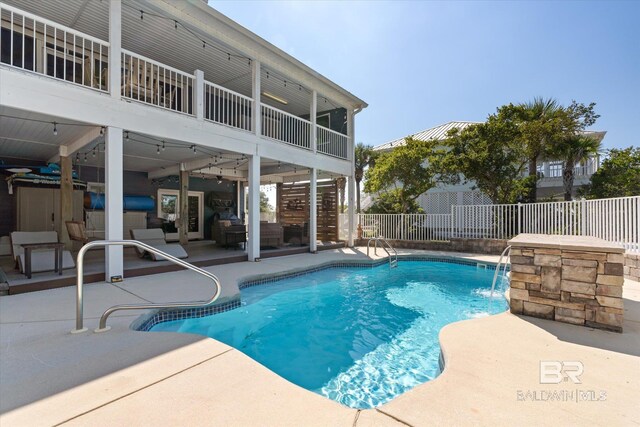 view of pool featuring pool water feature and a patio area