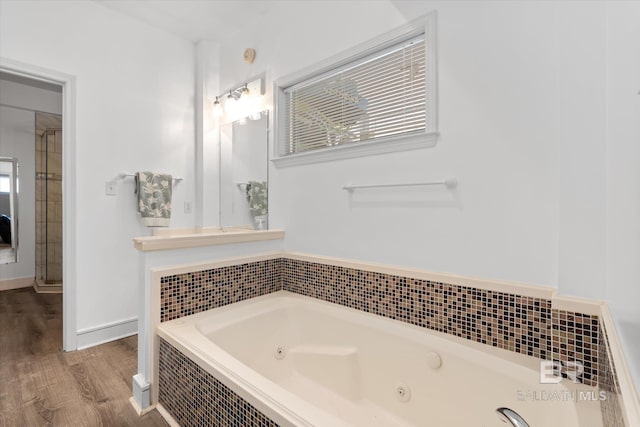 bathroom with hardwood / wood-style floors and plus walk in shower