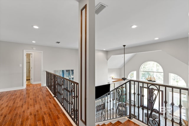 hall featuring lofted ceiling and wood-type flooring