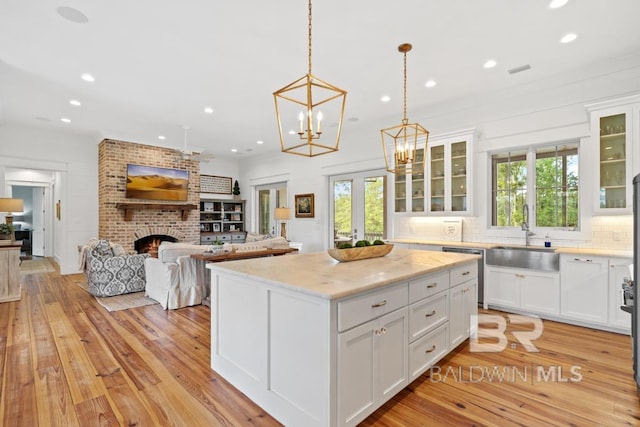 21151 Caveletti Cir, Fairhope, AL 36532 - kitchen with recessed lighting, dishwasher, tasteful backsplash, white cabinetry, and light wood finished floors