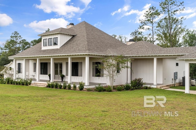 21151 Caveletti Cir, Fairhope, AL 36532 - view of front facade with a chimney, roof with shingles, a front lawn, and a porch