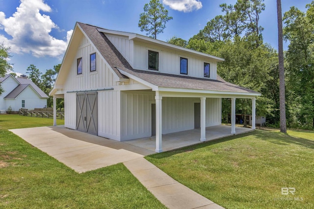 21151 Caveletti Cir, Fairhope, AL 36532 - view of front of property featuring a shingled roof, a front yard, and board and batten siding