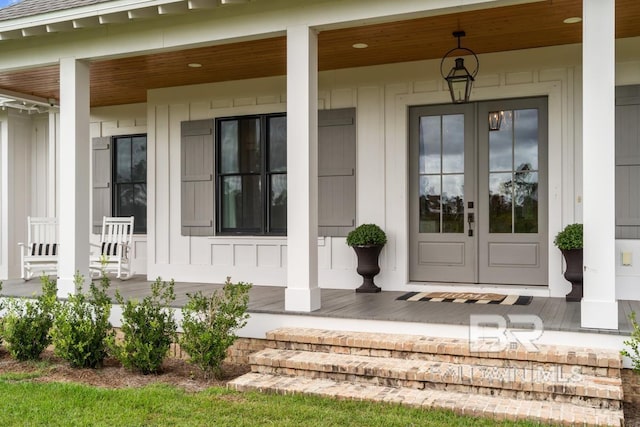 21151 Caveletti Cir, Fairhope, AL 36532 - property entrance featuring covered porch, board and batten siding, and french doors