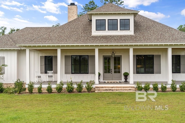 21151 Caveletti Cir, Fairhope, AL 36532 - back of house with covered porch, roof with shingles, board and batten siding, and a chimney