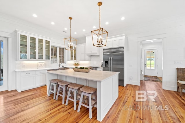 21151 Caveletti Cir, Fairhope, AL 36532 - kitchen with built in refrigerator, a chandelier, backsplash, white cabinetry, and recessed lighting