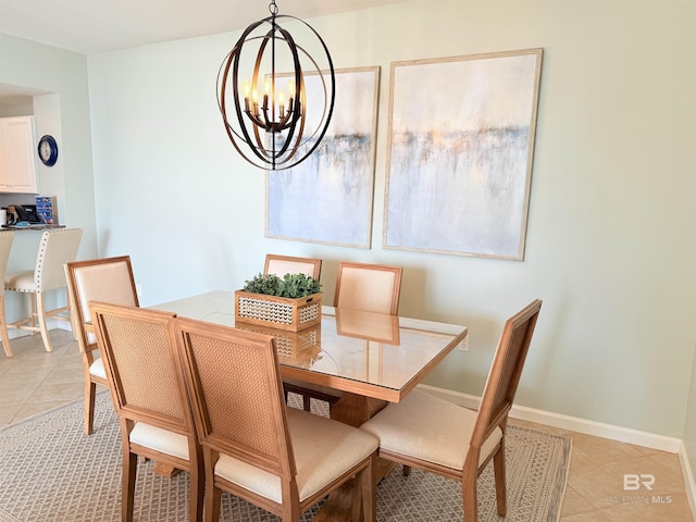 dining space featuring light tile patterned floors, baseboards, and an inviting chandelier