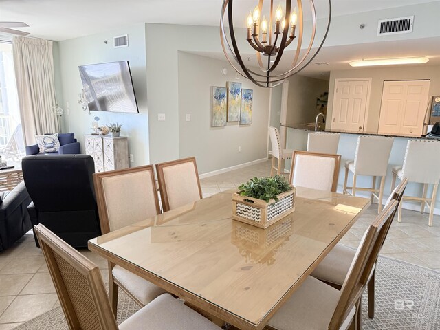 dining room featuring an inviting chandelier, light tile patterned floors, baseboards, and visible vents