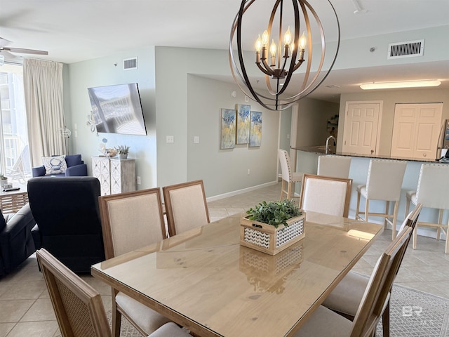 dining space with baseboards, light tile patterned floors, a notable chandelier, and visible vents