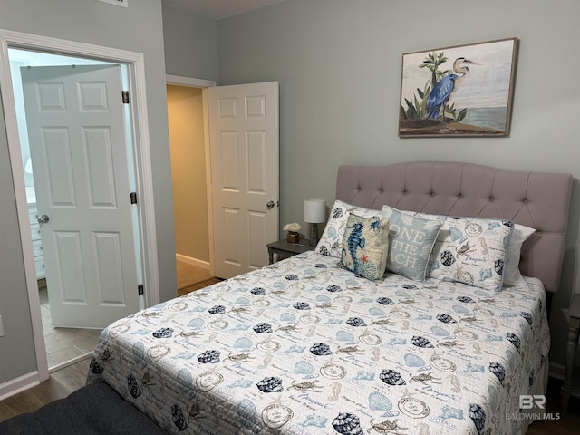 bedroom featuring baseboards and wood finished floors