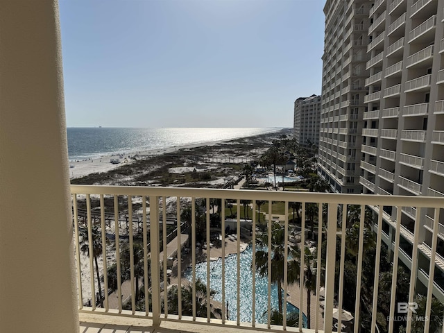 balcony featuring a beach view and a water view