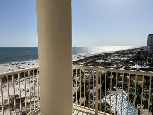balcony featuring a water view and a view of the beach