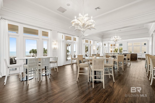 dining area featuring visible vents, a water view, dark wood-style flooring, a chandelier, and crown molding