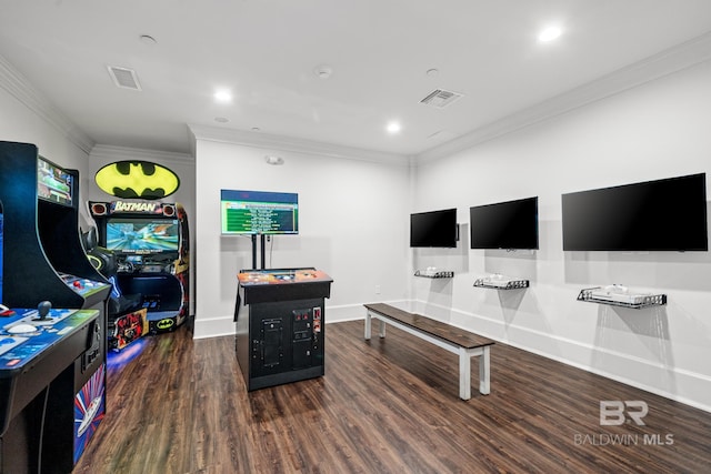 recreation room featuring crown molding, wood finished floors, baseboards, and visible vents