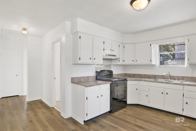 kitchen with light wood finished floors, a sink, white cabinets, black range with electric stovetop, and under cabinet range hood