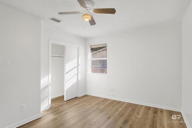 unfurnished bedroom with baseboards, a closet, and light wood finished floors