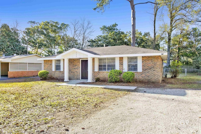 ranch-style house with brick siding and fence