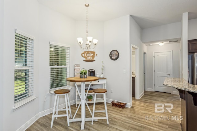 dining space with light hardwood / wood-style flooring