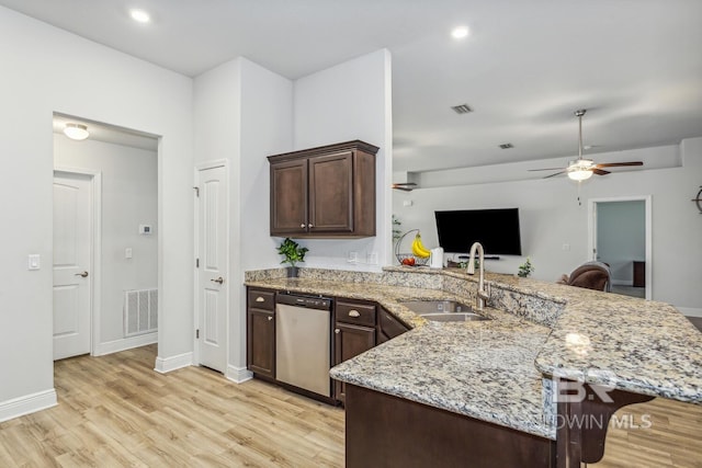 kitchen featuring ceiling fan, sink, kitchen peninsula, stainless steel dishwasher, and light hardwood / wood-style floors