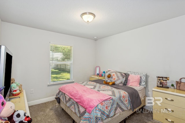 bedroom featuring dark carpet