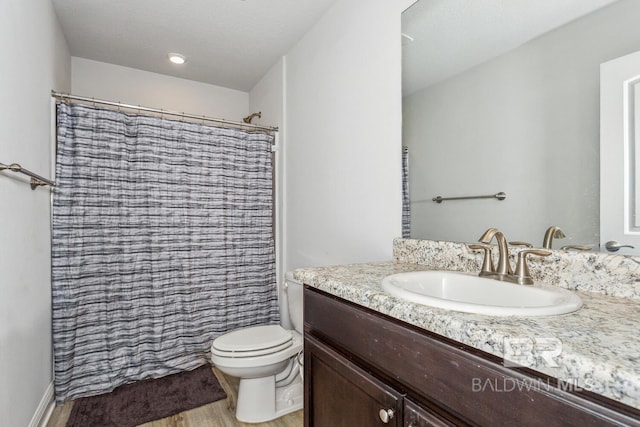 bathroom with vanity, hardwood / wood-style floors, toilet, and a shower with shower curtain