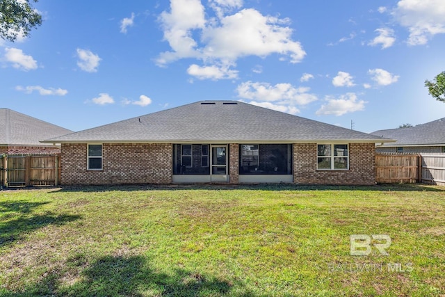 rear view of property featuring a yard