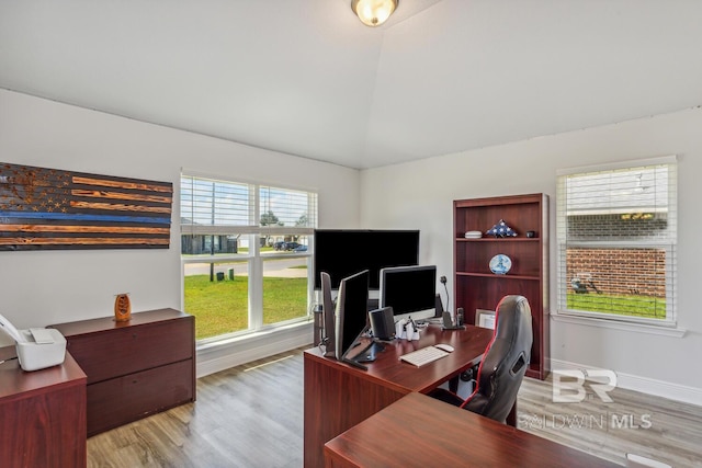 office area featuring light hardwood / wood-style flooring and lofted ceiling