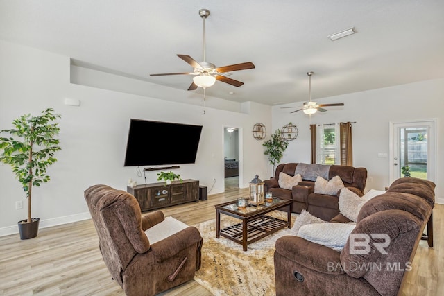 living room featuring ceiling fan and light hardwood / wood-style flooring