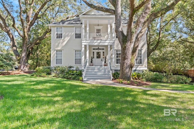 neoclassical home with a front lawn and a balcony