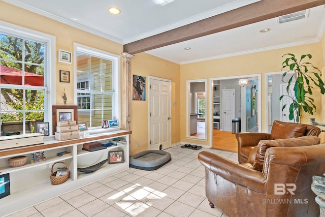 sitting room with crown molding and light tile patterned floors