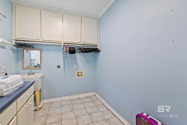 laundry room with electric dryer hookup, washer hookup, cabinets, ornamental molding, and light tile patterned floors