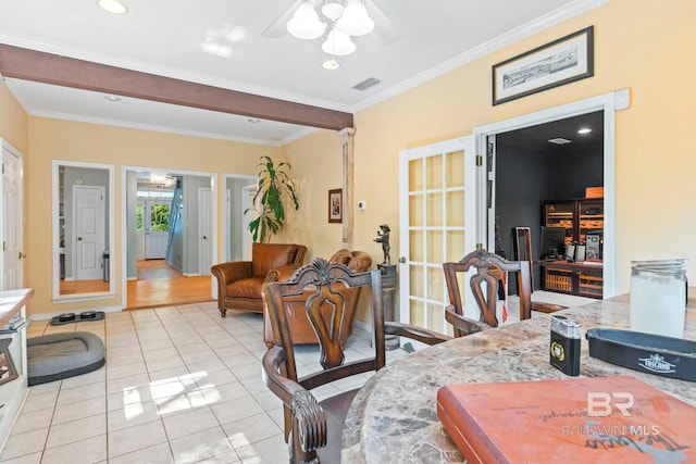 tiled living room featuring crown molding and ceiling fan